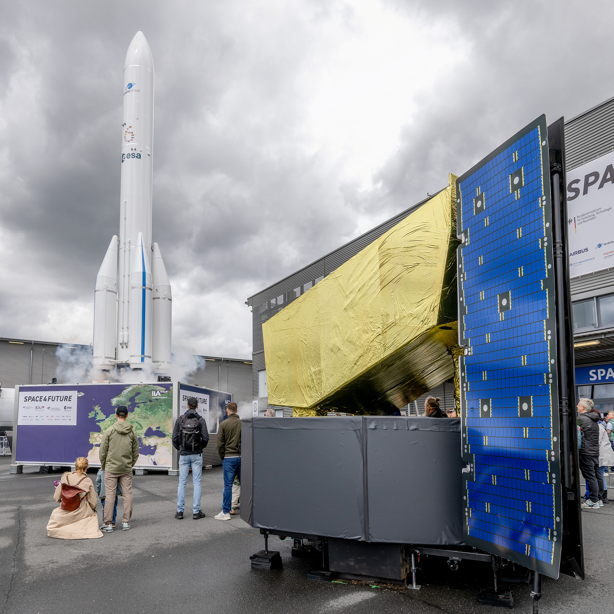 Satellite structure with solar panel and Ariane 6 model at the Space Pavilion